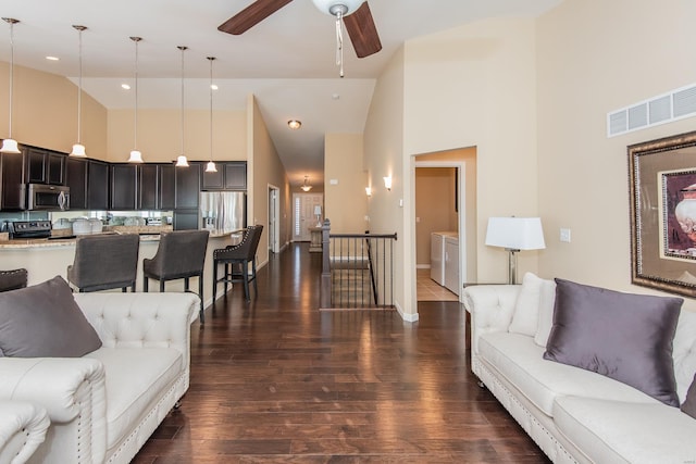 living area featuring high vaulted ceiling, dark wood-style floors, a ceiling fan, baseboards, and recessed lighting