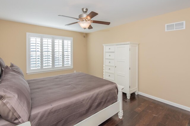 bedroom featuring dark wood-style flooring, baseboards, and a ceiling fan