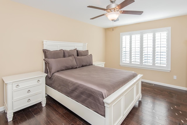 bedroom featuring dark wood-type flooring, baseboards, and ceiling fan
