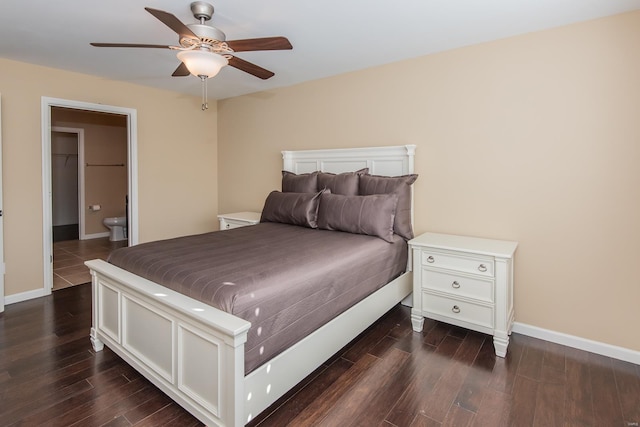 bedroom with dark wood finished floors, baseboards, ensuite bath, and a ceiling fan