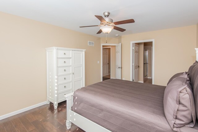 bedroom with dark wood-style flooring, baseboards, and ceiling fan