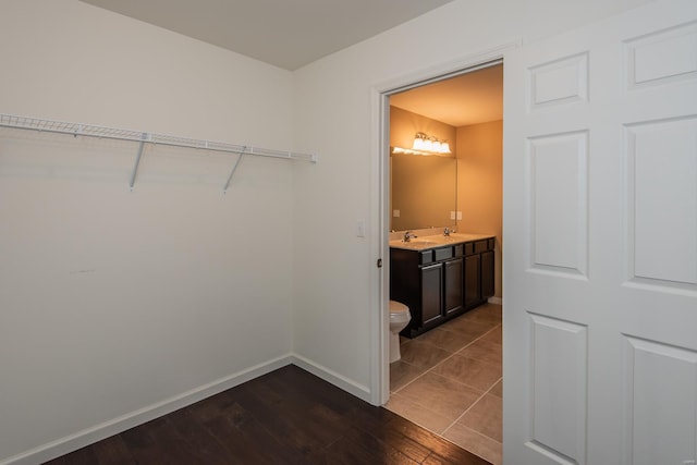 bathroom featuring hardwood / wood-style floors, baseboards, vanity, and toilet