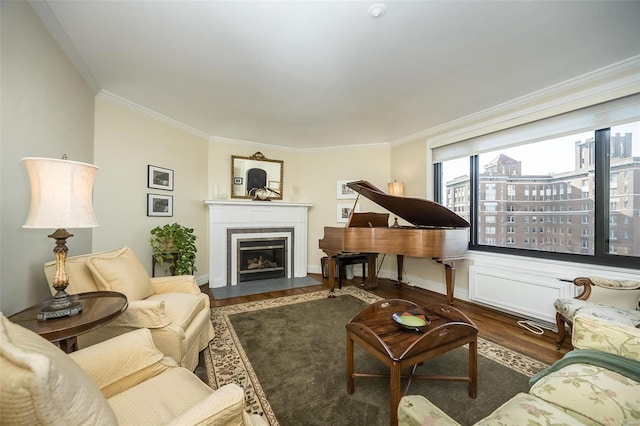 living area featuring wood finished floors, ornamental molding, and a fireplace with flush hearth