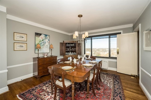 dining space featuring dark wood-type flooring and a chandelier