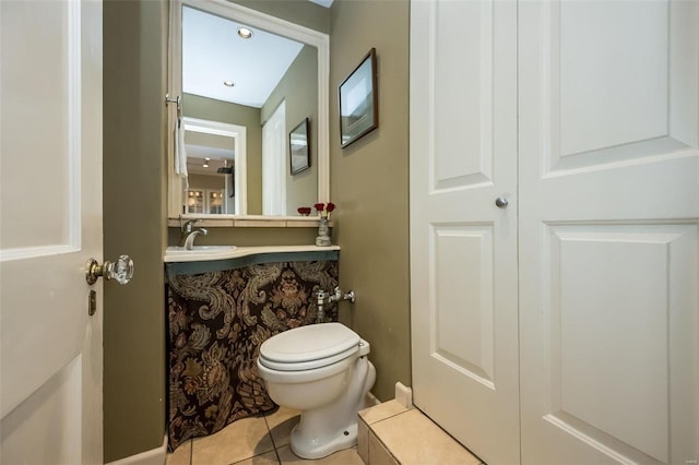 bathroom with toilet, tile patterned floors, and vanity