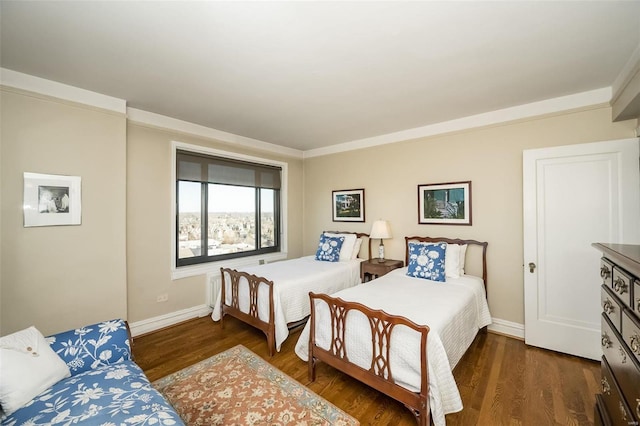 bedroom with wood finished floors and baseboards