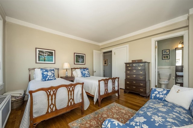 bedroom featuring wood finished floors, ensuite bathroom, and ornamental molding