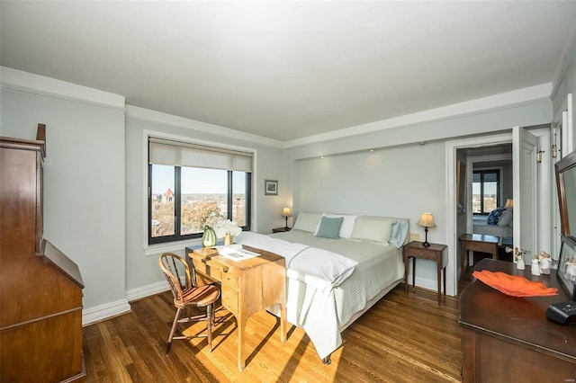 bedroom with wood finished floors, multiple windows, and baseboards