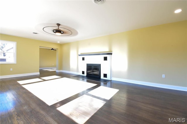 305 E Hauser St, Litchfield, IL 62056 - unfurnished living room featuring wood finished floors, baseboards, a ceiling fan, a fireplace, and recessed lighting