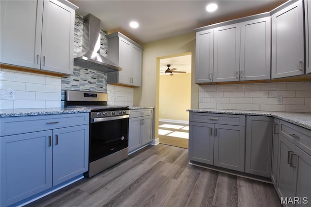 305 E Hauser St, Litchfield, IL 62056 - kitchen featuring stainless steel range with electric cooktop, wall chimney exhaust hood, baseboards, ceiling fan, and dark wood-style floors