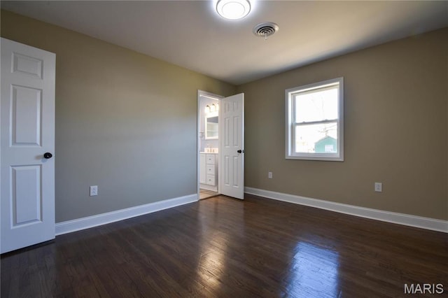 305 E Hauser St, Litchfield, IL 62056 - unfurnished room with baseboards and dark wood-style floors