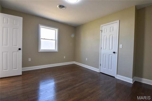 305 E Hauser St, Litchfield, IL 62056 - spare room with dark wood-type flooring and baseboards