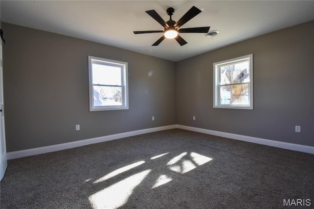 305 E Hauser St, Litchfield, IL 62056 - empty room featuring healthy amount of natural light, a ceiling fan, baseboards, and dark colored carpet