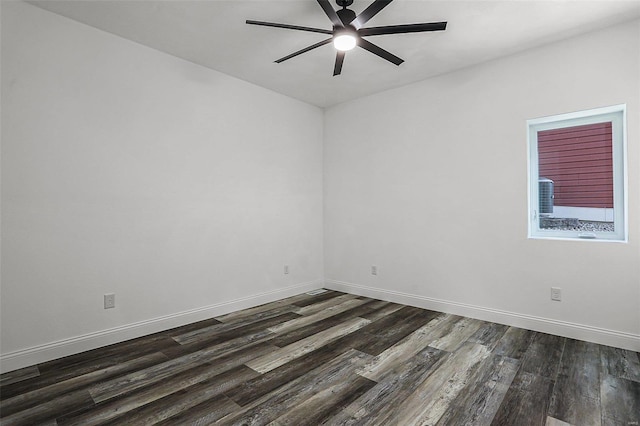 empty room with ceiling fan, dark wood-type flooring, and baseboards