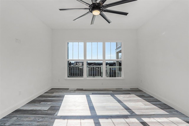 unfurnished room featuring ceiling fan, baseboards, and wood finished floors