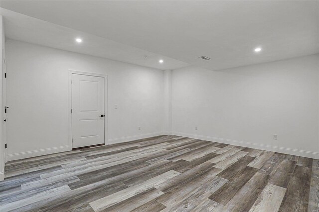 below grade area with wood finished floors, recessed lighting, and baseboards