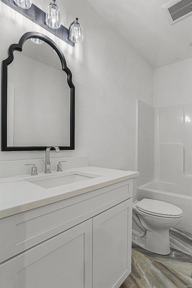 bathroom with toilet, vanity, shower / bathtub combination, and marble finish floors