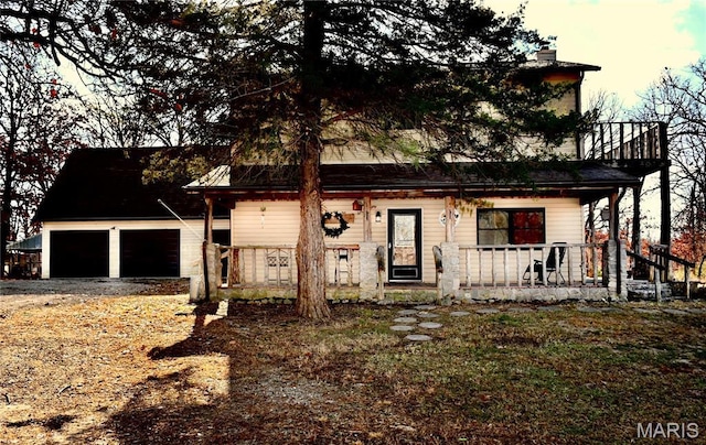 26 Gap Rd, Tunas, MO 65764 - view of front of home featuring covered porch, a chimney, driveway, and a garage
