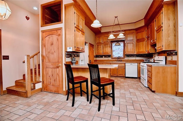 26 Gap Rd, Tunas, MO 65764 - kitchen featuring white appliances, a sink, a peninsula, light countertops, and hanging light fixtures
