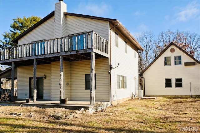 26 Gap Rd, Tunas, MO 65764 - rear view of property featuring a chimney, covered porch, and a deck