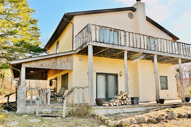 26 Gap Rd, Tunas, MO 65764 - rear view of house featuring a porch and a chimney