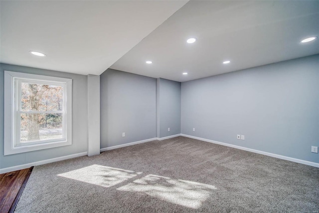 carpeted empty room featuring baseboards and recessed lighting