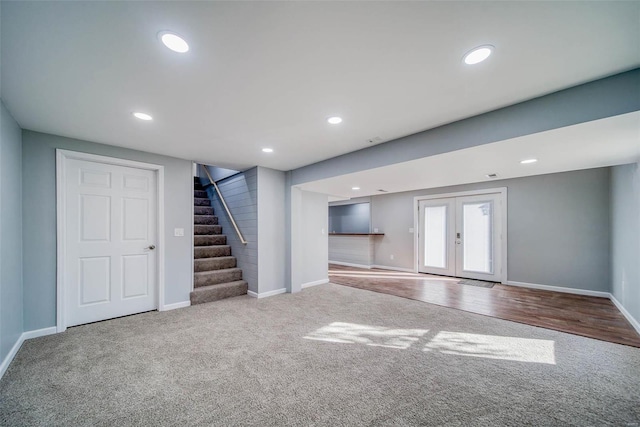 unfurnished living room featuring carpet floors, french doors, stairway, baseboards, and recessed lighting