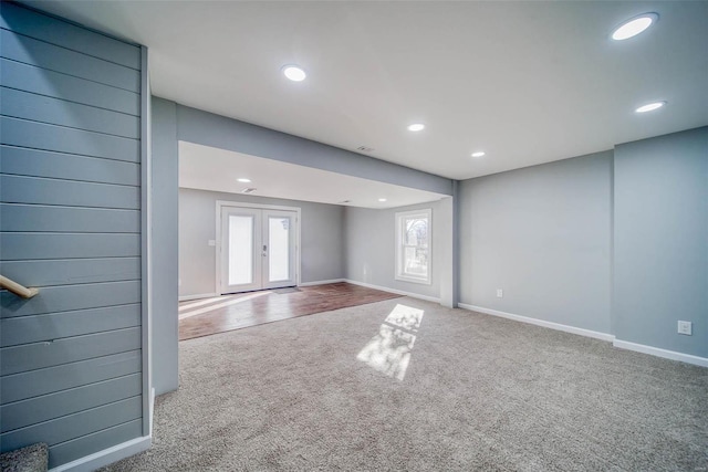 unfurnished living room with carpet flooring, recessed lighting, french doors, and baseboards