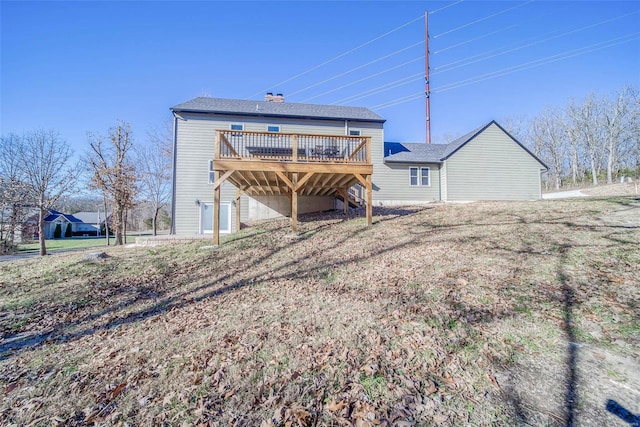 rear view of property with a wooden deck