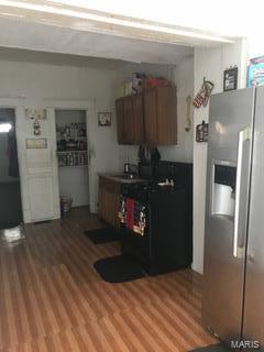 5234 Terry Ave, Saint Louis, MO 63115 - kitchen featuring stainless steel refrigerator with ice dispenser and light wood finished floors