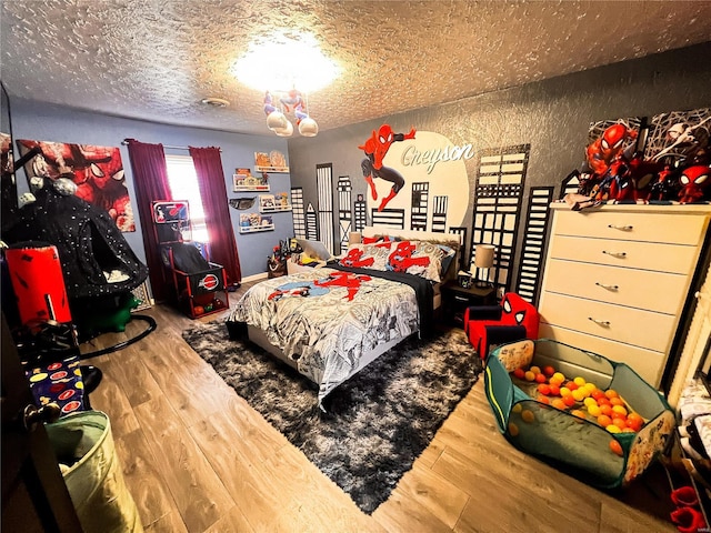 9559 E Dix Irvington Rd, Dix, IL 62830 - bedroom featuring wood finished floors, a textured ceiling, and a textured wall