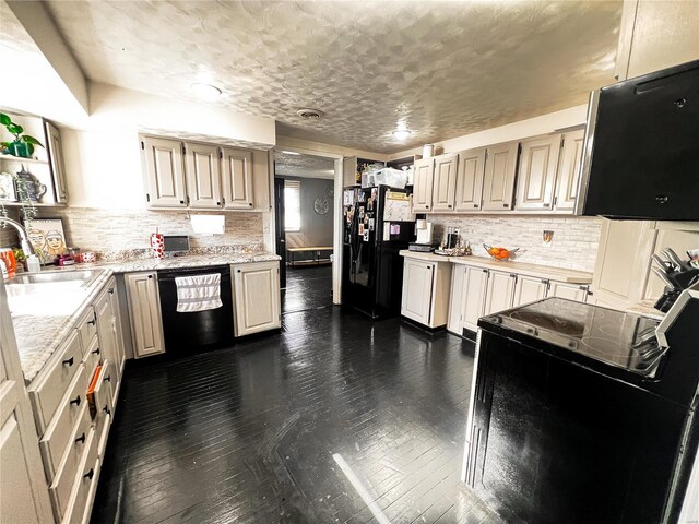 9559 E Dix Irvington Rd, Dix, IL 62830 - kitchen featuring black appliances, light countertops, a sink, decorative backsplash, and a textured ceiling