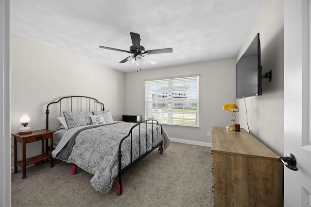 carpeted bedroom with a ceiling fan and baseboards
