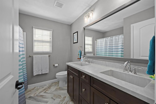 bathroom with toilet, marble look tiles, double vanity, baseboards, and curtained shower