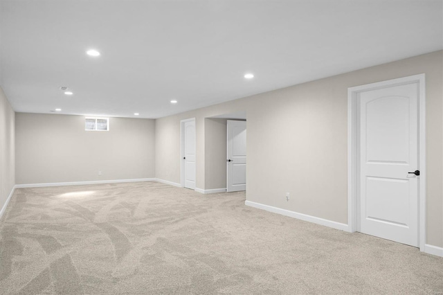 basement featuring recessed lighting, light carpet, and baseboards
