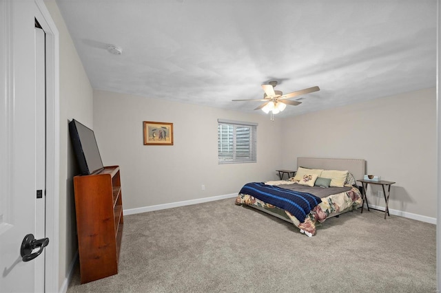 carpeted bedroom with baseboards and a ceiling fan