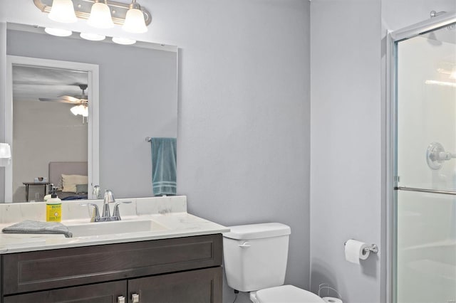 full bath featuring a stall shower, toilet, a ceiling fan, and vanity