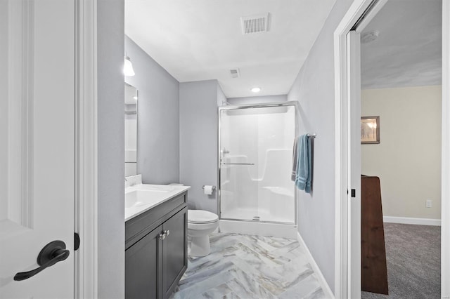 bathroom with a stall shower, vanity, baseboards, and toilet