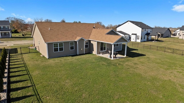 rear view of property featuring a patio area, a shingled roof, and a residential view