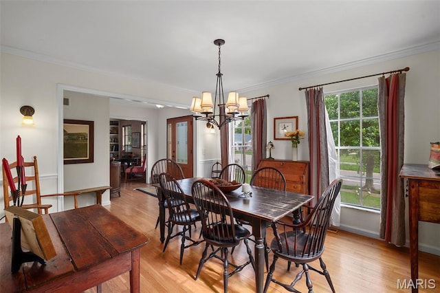 729 W Lockwood Ave, Saint Louis, MO 63122 - dining area featuring a chandelier, ornamental molding, and light wood-style flooring