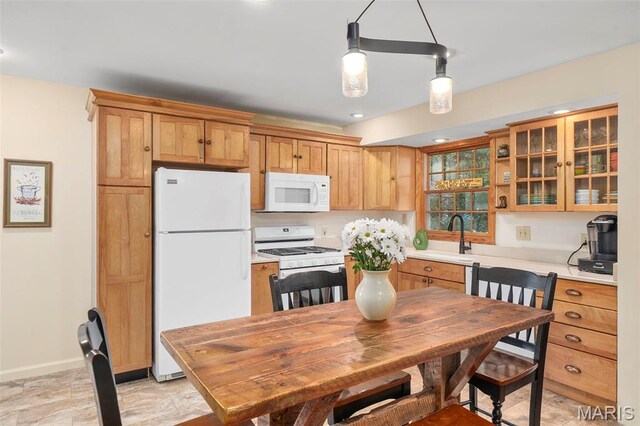 729 W Lockwood Ave, Saint Louis, MO 63122 - kitchen with white appliances, light countertops, glass insert cabinets, pendant lighting, and recessed lighting