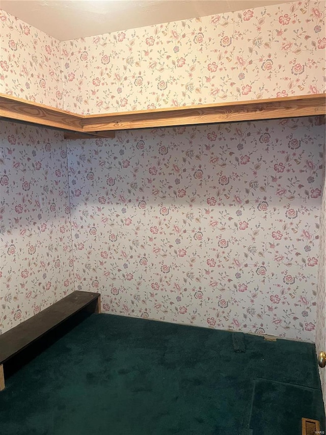 carpeted spare room with wallpapered walls