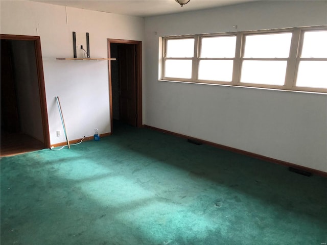 unfurnished bedroom with carpet floors and baseboards
