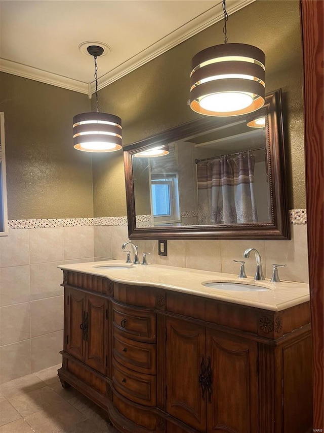 bathroom featuring tile walls, double vanity, ornamental molding, and tile patterned floors