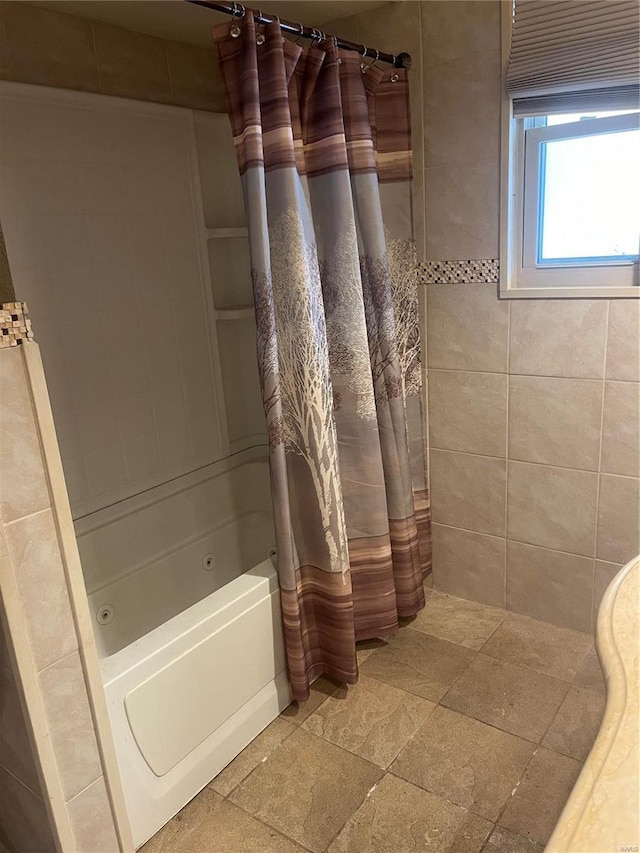 bathroom with shower / tub combo and stone tile flooring