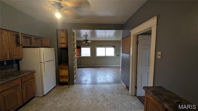 12532 Bellefontaine Rd, Saint Louis, MO 63138 - kitchen featuring a ceiling fan, freestanding refrigerator, brown cabinetry, and light flooring