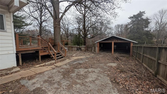 12532 Bellefontaine Rd, Saint Louis, MO 63138 - fenced backyard featuring a deck and a detached carport