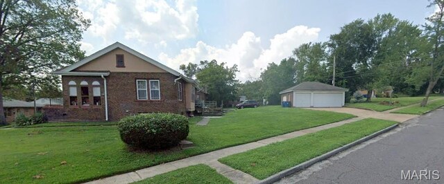 104 Emerling Dr, Saint Louis, MO 63121 - view of property exterior with a garage, an outbuilding, a yard, and brick siding