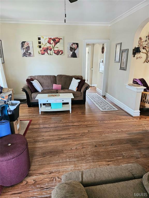 104 Emerling Dr, Saint Louis, MO 63121 - living area with ornamental molding, baseboards, arched walkways, and wood finished floors