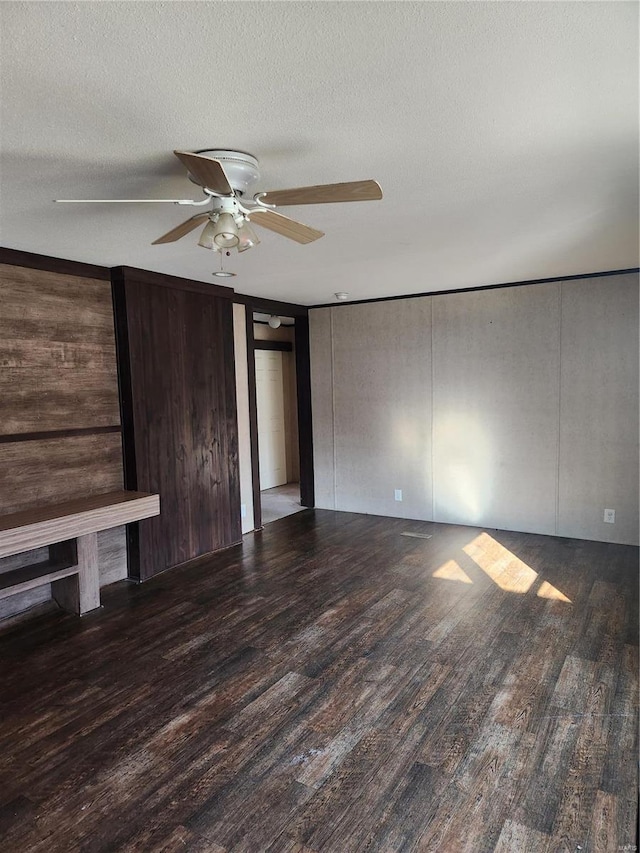 15005 Carthage Rd, Dixon, MO 65459 - unfurnished living room with wood finished floors, ceiling fan, and a textured ceiling